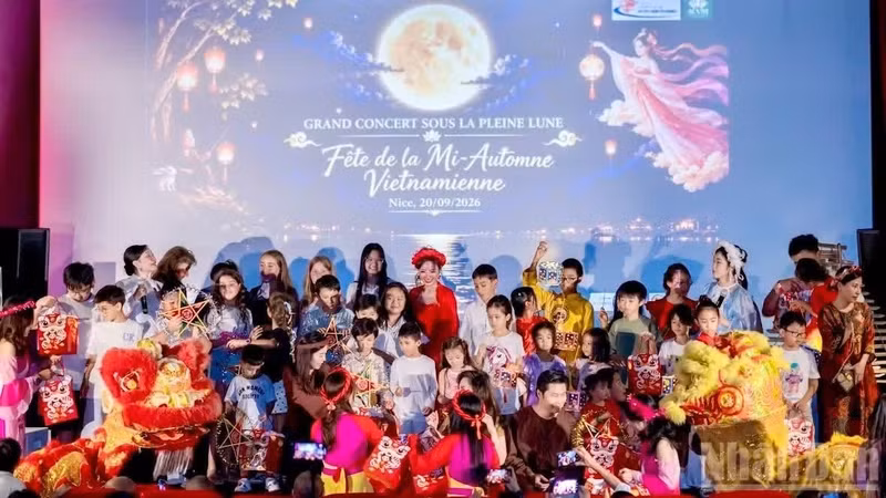Des enfants montent sur scène pour participer à la procession des lanternes de la fête de la mi-automne aux côtés de la Fée de la Lune, de Chu Cuoi et des lions-dragons, et recevoir des cadeaux des organisateurs. (Photo : KHAI HOAN)