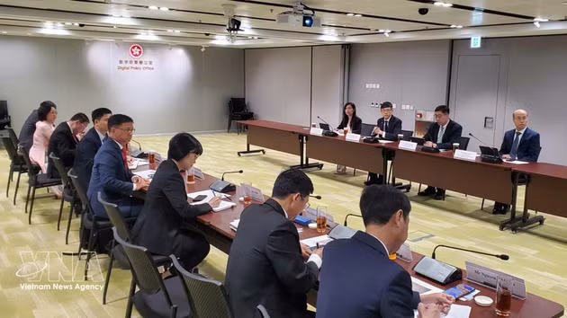 Séance de travail entre la délégation vietnamienne et des responsables des politiques numériques de Hong Kong. Photo : VNA.