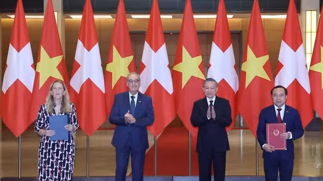 Le secrétaire général du Parti et président de la République, To Lam, et le président de suisse, Guy Parmelin assistent à la cérémonie de remise des documents de coopération entre les deux pays. Photo : VNA.