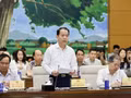 Le ministre de la Justice, Hoang Thanh Tung, présente le rapport de synthèse sur le projet de loi sur le développement urbain. Photo: VNA
