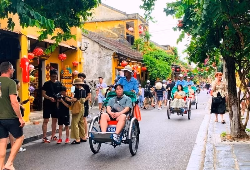 Des touristes dans la vieille ville de Hoi An, au centre du Vietnam. Photo publiée avec l'aimable autorisation du journal Phap luat (Loi).