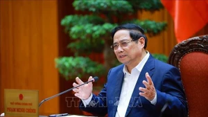 Le Premier ministre Pham Minh Chinh s'exprime lors de la réunion, à Hanoi, le 24 décembre. Photo: VNA