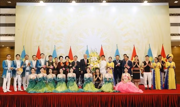 Le Président vietnamien, Vo Van Thuong, et le Président du Kazakhstan, Kassym-Jomart Tokaïev, offrent des fleurs aux artistes lors de la réception. Photo : VNA.