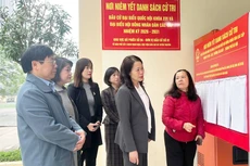 Les dirigeants du quartier de Cau Giay ont inspecté le travail d’affichage officiel ainsi que la préparation des infrastructures matérielles au sein du bureau de vote n°4. Photo : HNM