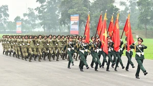 L’Armée populaire avance résolument sous le drapeau glorieux du Parti