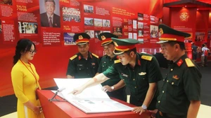 Cadres et officiers de la Division 3 (Région militaire 1) découvrent la lecture de livres électroniques lors de l’exposition. Photo : Nhân Dân.