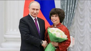 Le président russe Vladimir Poutine et Thai Huong, Héroïne du travail du Vietnam et présidente du Conseil stratégique du groupe laitier TH. Photo : NDEL