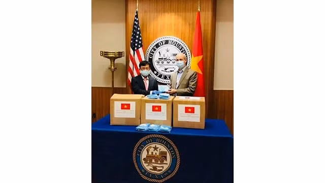 Le consul général vietnamien à Houston Luong Quôc Huy remet 3 000 masques aux dirigeants de la ville de Houston.