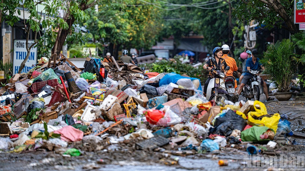 Selon Tran Minh Hoang, directeur de la Société par actions de l'environnement et de l'urbanisme de Phu Yen, immédiatement après le retrait des eaux, 400 ouvriers de son établissement ont travaillé sans relâche, parvenant à dégager en grande partie 6 000 tonnes de boue et 1 500 tonnes de déchets volumineux. Photo : NDEL