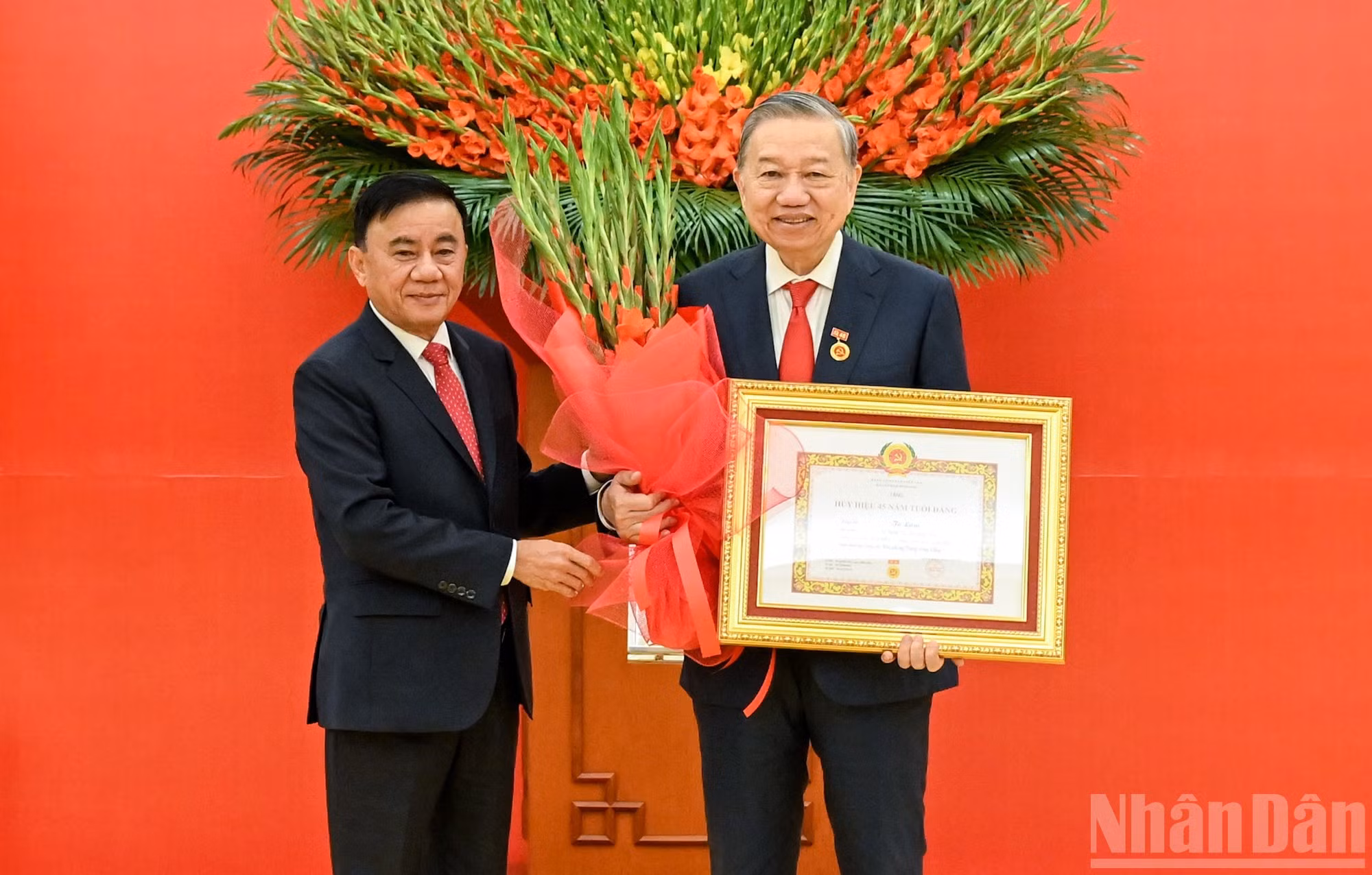 Le permanent du Secrétariat, Tran Cam Tu, remet l’insigne des 45 ans d’adhésion au Parti au secrétaire général Tô Lâm. Photo : NDEL.
