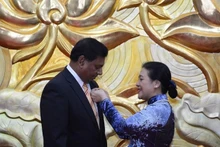 La présidente de la VUFO, Nguyên Phuong Nga attache l’Insigne de l’amitié à l’ambassadeur du Sri Lanka au Vietnam Prasanna Gamage sur la poitrine. Photo: VNA