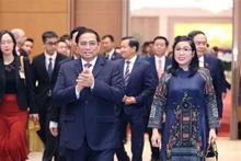 Le Premier ministre Pham Minh Chinh et son épouse présidant un banquet en l’honneur du corps diplomatique à Hanoi, avant la fête traditionnelle du Nouvel An lunaire (Têt). Photo : VNA.