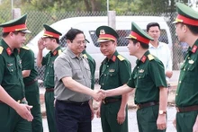 Le Premier ministre et des responsables du Corps d'armée 12 (Compagnie générale de la construction Truong Son). Photo : VNA.