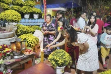 Comme les Vietnamiens dans le pays, ceux au Laos vont à la pagode pour divers buts tels que les prières pour le gain de l’argent, la fortune, la paix, la chance en amour, la bonne santé pour eux-mêmes et pour leurs proches. Photo : VNA