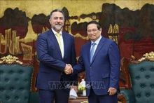 Le Premier ministre Pham Minh Chinh (à droite) serre la main du vice-président chargé des opérations de l’Autorité d’investissement d’Oman (OIA), le cheikh Nasser bin Suliman Al Harthi, à Hanoi, le 29 mai. Photo : VNA.