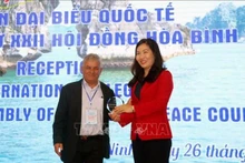 Un représentant des délégués internationaux à la 22e Assemblée du Conseil mondial de la paix remet un cadeau à la vice-présidente du Comité populaire de la province de Quang Ninh, Nguyên Thi Hanh. Photo : VNA.
