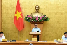 Le Premier ministre Pham Minh Chinh préside une réunion périodique du gouvernement pour évaluer les performances socio-économiques de juillet. Photo : VNA.
