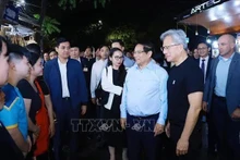 Le Premier ministre vietnamien Pham Minh Chinh (2e de droite à gauche) et le président-directeur général de NVIDIA Jensen Huang (droite) rencontre des habitants de Hanoï jeudi soir. Photo : VNA.