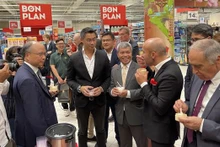 Des délégués dégustent le riz vietnamien du groupe Loc Troi au supermarché Carrefour Collagen. Photo : VNA.