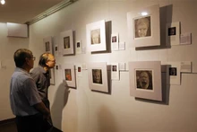 Des visiteurs visitent les peintures de l'espace d'exposition "Finding Parkinsons" de l'artiste David Thomas. Photo : VNA.