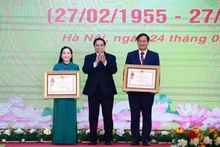 Le Premier ministre Pham Minh Chinh (au centre) remet l’Ordre du travail de troisième classe au professeur associé Dr Dào Xuân Co, directeur de l’Hôpital Bach Mai, et le titre de docteure émérite à Nguyên Thi Mai Ngoc, à l’Institut national de cardiologie du Vietnam relevant de l’Hôpital Bach Mai. Photo : VNA.