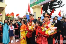 Des élèves offrent des fleurs aux deux ministres de la Défense, Phan Van Giang et Dong Jun Photo : qdnd.vn