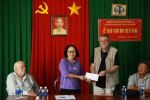 Grega Pierre Emlile J remet 1,1 mille euros et 10,8 millions de dongs à l’Association des victimes de l'agent orange/dioxine de Dong Nai. Photo: Dacamvietnam