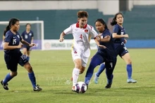 L’équipe du Vietnam (maillot blanc) bat celle de Singapour au score 11 - 0. Photo: VNA.