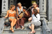 Des touristes étrangères découvrent des instruments de musique vietnamiens au temple Thai Vi, province de Ninh Binh. Photo : VNA.