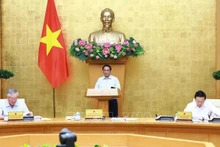 Le Premier ministre Pham Minh Chinh préside la réunion législative mensuelle du gouvernement. Photo: VNA