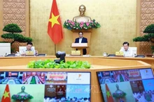 Le Premier ministre Pham Minh Chinh préside la réunion de juin du gouvernement. Photo : VNA.