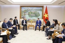 Rencontre entre le Vice-PM vietnamien Trân Hông Hà et le directeur général du groupe chinois Power China, Wang Bin. Photo : VNA.