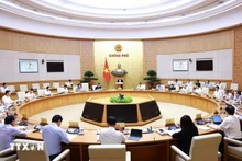 Lors de la réunion du gouvernement sur l'élaboration des lois en juillet. Photo : VNA.