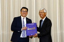 Vo Van Hoan, vice-président du Comité populaire de Hô Chi Minh-Ville (à droite) remet un livre à Joseph Nguyen, sénateur de l'État de Washington (États-Unis). Photo: VNA.