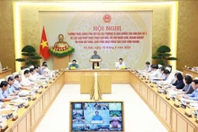 Le Premier ministre Pham Minh Chinh préside une conférence en ligne sur le traitement des conséquences du typhon Yagi. Photo : VNA.