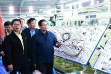 Le Premier ministre Pham Minh Chinh visite une chaîne de production d'une entreprise à Quang Nam. Photo : VNA. 