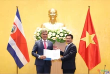 Le ministre costaricain du Commerce extérieur, Rica Manuel Tovar (gauche), remet au ministre de l'Industrie et du Commerce, Nguyen Hong Dien, une note sur la reconnaissance par son pays du statut d'économie de marché du Vietnam. Photo : qdnd.vn