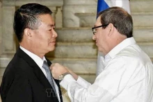 Le ministre cubain des Affaires étrangères, Bruno Rodríguez Parrilla (droite) remet l’Ordre de l'amitié à l'ambassadeur du Vietnam à Cuba Le Thanh Tung. Photo : VNA.