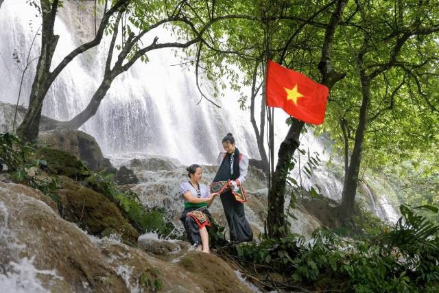 Des jeune filles Thaï posent avec grâce au bord de la cascade Reu. Photo: nhandan.vn 5-20.jpg