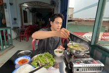 Jongrak déguste la fondue vietnamienne à la sauce de poisson à Hô Chi Minh-Ville. Photo : HanQuocBros