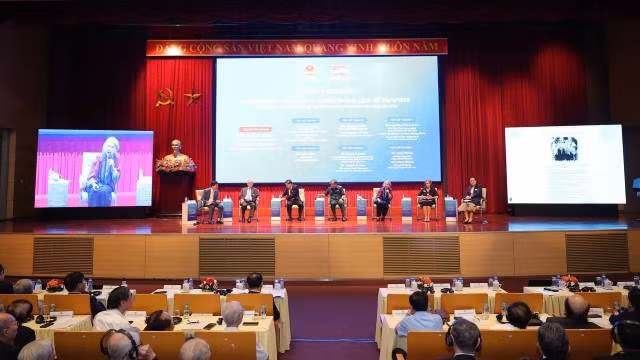 Les experts échangent lors du colloque scientifique international "50 ans de réunification nationale : Le rôle de la diplomatie dans la construction de la paix, hier et aujourd'hui". Photo : nhandan.vn