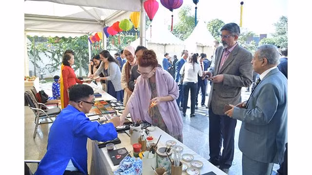 Les visiteurs prennent plaisir à contempler les estampes populaires de Dông Hô et à réaliser ses propres peintures à la laque poncée. Photo: baoquocte.vn