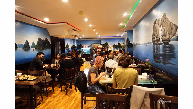 Des peintures à l'huile de paysages vietnamiens au restaurant Viet Rest. Photo : Vu Kim Thanh.