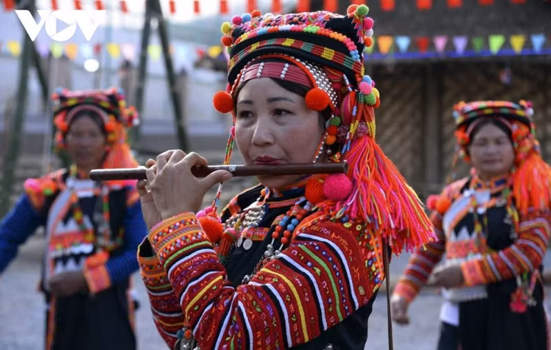 Une femme Hà Nhi joue de la flûte lors de la Fête du Têt traditionnel. Photo: VOV