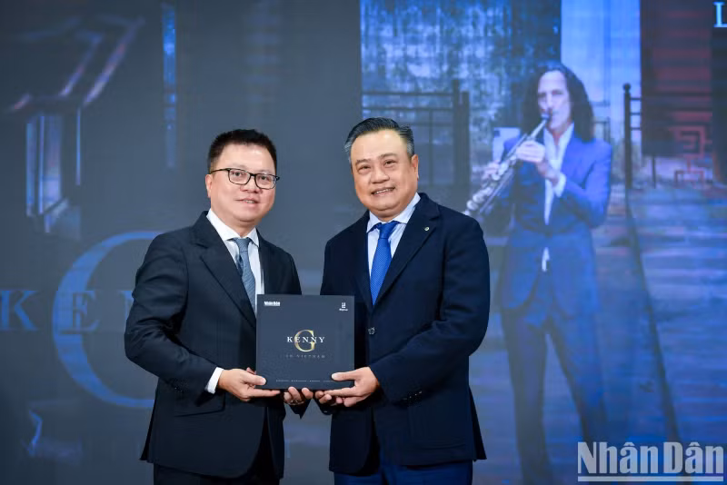 Lê Quôc Minh, édacteur en chef du Journal Nhân Dân, remet le MV « Going Home » au dirigeant de la ville de Hanoi. Photo : nhandan.vn