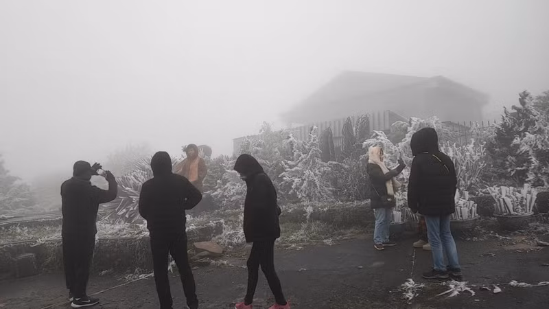 Les touristes affluent avec impatience au sommet de Mâu Son pour regarder la neige. Photo: VOV