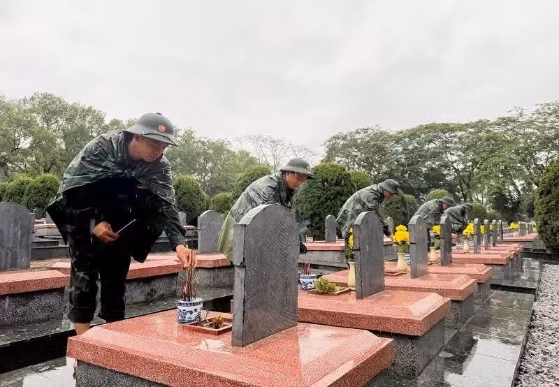 Des soldats du commandement militaire provincial de Dien Bien brûlent de l'encens sur les tombes des soldats tombés au champ d'honneur au cimetière des martyrs de Doc Lap. Photo: NDEL