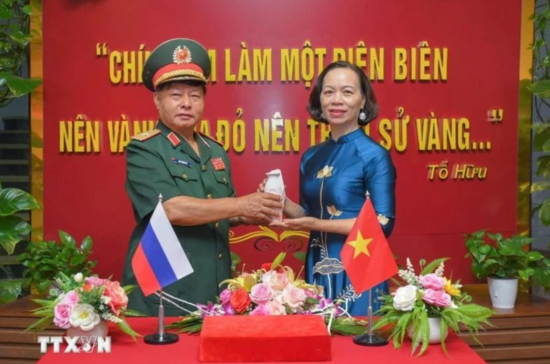 Le général Luu Trong Lu, président de l’Association des anciens combattants de la province de Dien Bien, remet l’urne contenant la terre sacrée à Vu Thi Tuyet Nga, directrice du Musée de la Victoire de Diên Biên Phu. Photo : VNA.