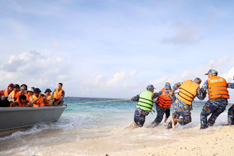 Les soldats tirent un canot pour faciliter son embarquement sur l'île.