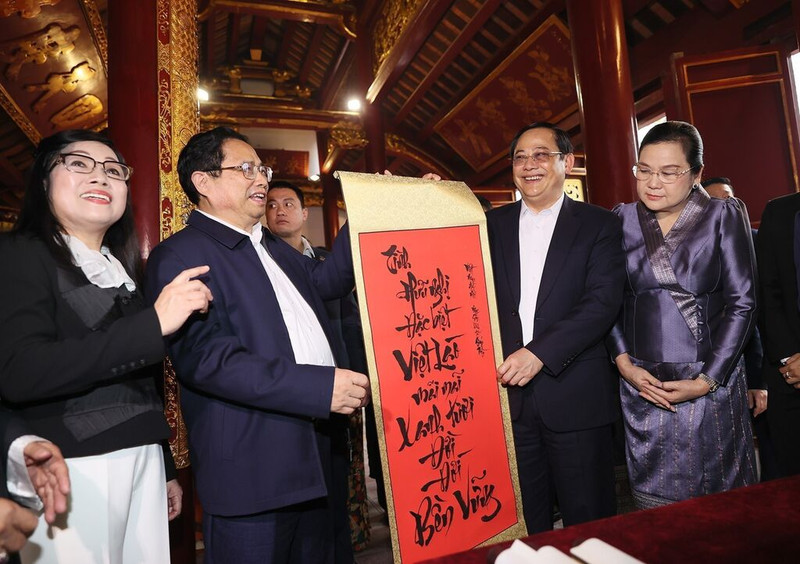 Le PM vietnamien, Pham Minh Chinh, offre à son homologue laotien, Sonexay Siphandone, une calligraphie en vietnamien signifiant que l’amitié vietnamo-lao à jamais verte et éternellement solide, le 7 janvier à Hanoi. Photo : VNA.